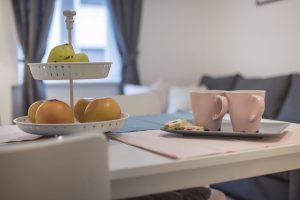Fruit and two mugs of coffee on the table in Apartment Zlata, an apartment in Zagreb for tourists